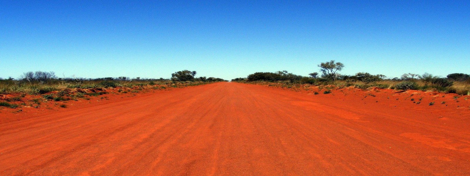 An outback road stretching towards the horizon in remote Australia